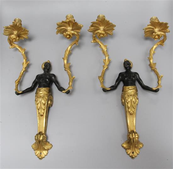 A pair of Louis XV style patinated and gilt bronze two-light figural Nubian wall sconces